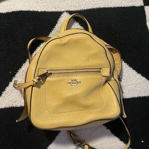 Yellow coach mini backpack.